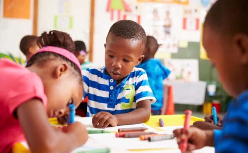 Group of children coloring. 