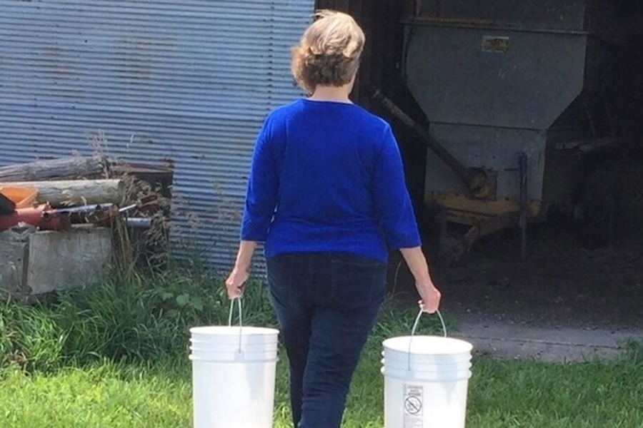 A woman walking on a farm. 