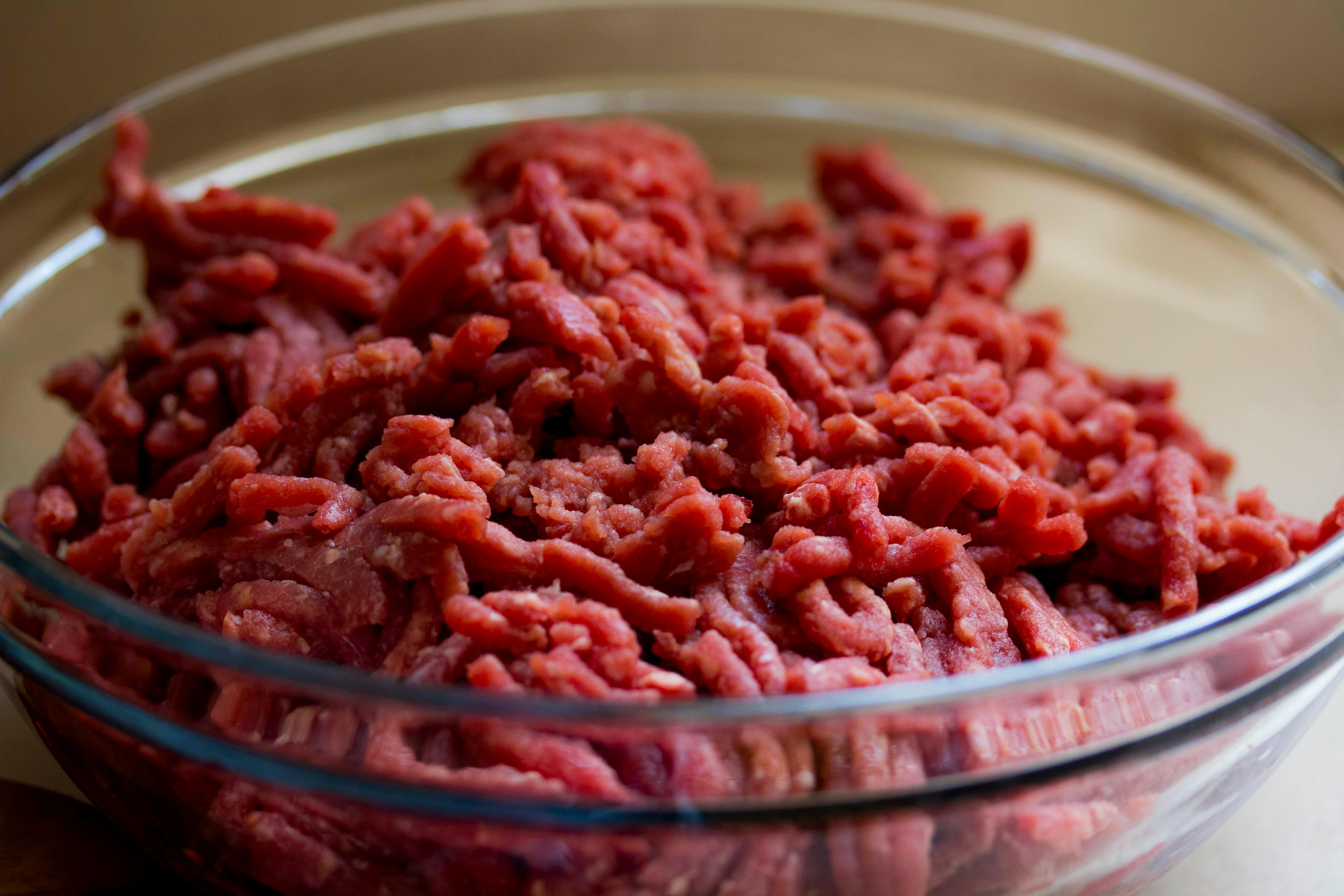 A bowl with ground beef in it.