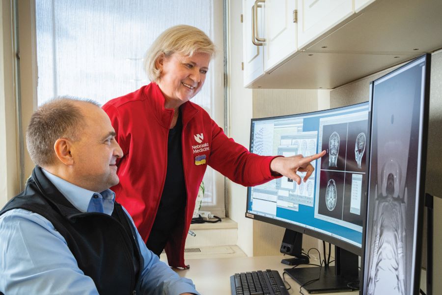 Two UNMC researchers review CT scans on the computer.