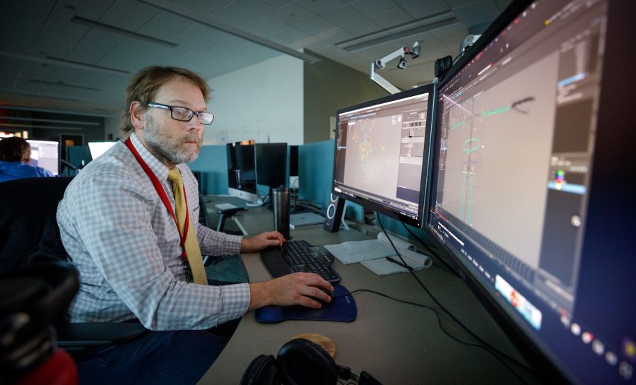 UNMC expert works on the computer using research software.