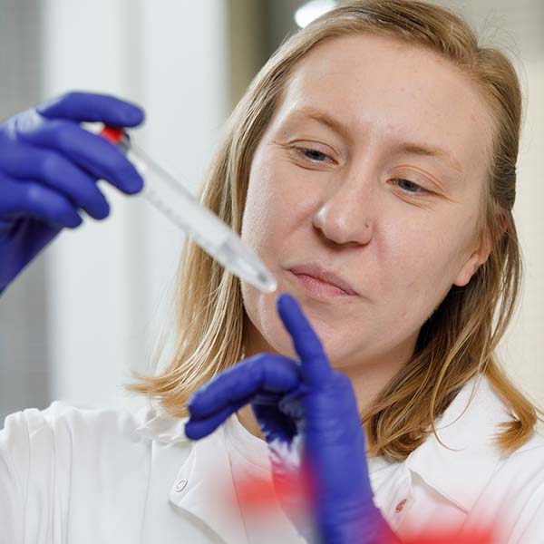 Female College of Public Health student works in a lab.