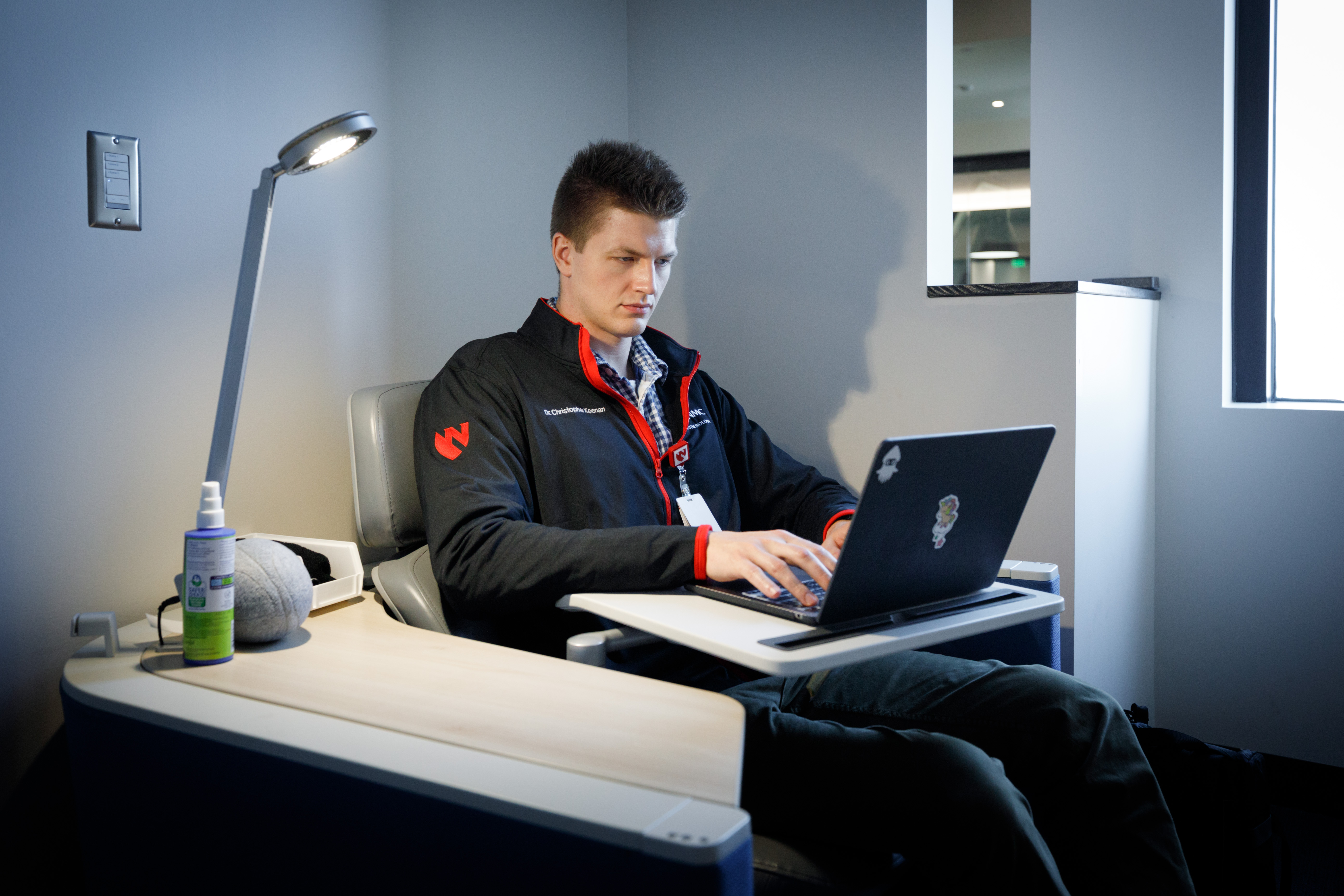 A male student works on a laptop