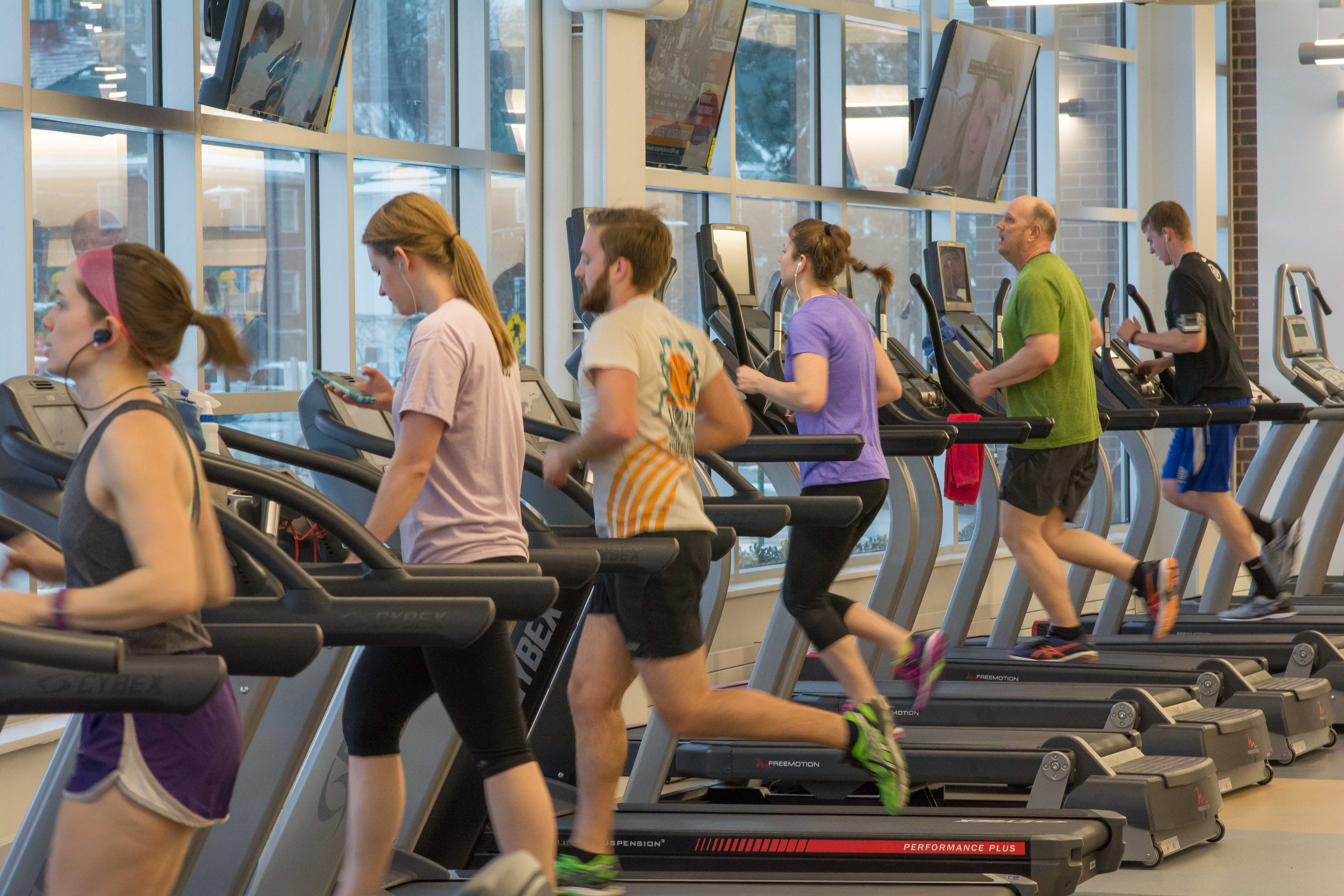 men and women walking and running on treadmills