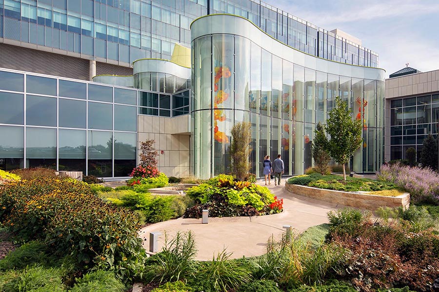 Two people walking in the UNMC healing gardens.