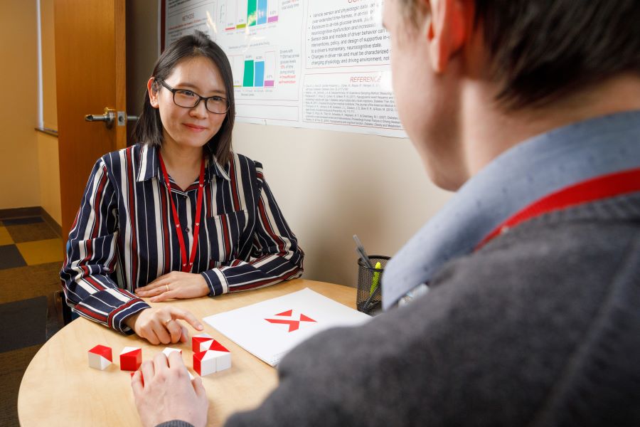 Two UNMC researchers meet to test their research procedures.